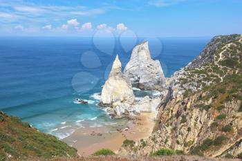 Two picturesque cliffs of white sandstone, resembling a portion of ice cream. Atlantic coast of Portugal