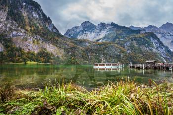 Berchtesgaden in Germany on the border with Austria. Famous lake Konigssee. Pier for tourist pleasure boats. The concept of active tourism and ecotourism
