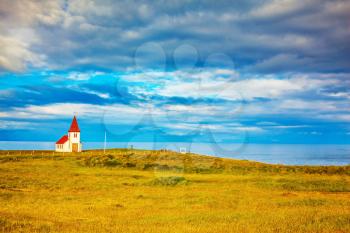  Iceland. White Chapel with red roof on the northern fjord