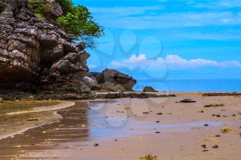 Rest of the Andaman Sea. Rocks of the island in the shallow waters and beautiful beaches with fine yellow sand