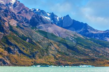 Argentina, Patagonia. Icebergs floating in the emerald water of the mountain lake