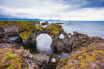 Magical coastal cliffs fishing village Arnastapi. July day in Iceland