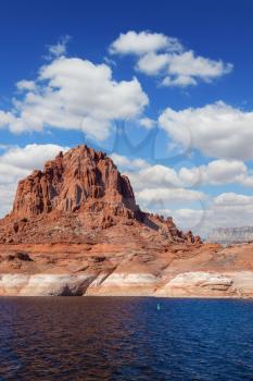 Scenic huge artificial pond Powell on the Colorado River, USA. The lake is surrounded by picturesque banks of red sandstone. Walk around the lake Powell at sunset