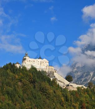 The castle is situated on top of the mountain and surrounded by dense forest.  Majestic medieval Palase Hohenwerfen