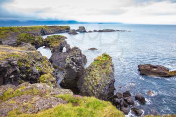 July day in Iceland. Magical coastal cliffs fishing village Arnastapi