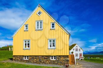 The charming rustic rural house on green lawn. Travel to Iceland