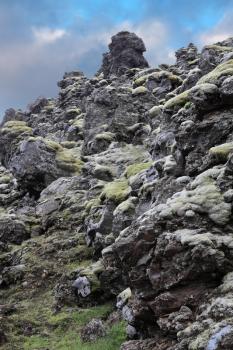 National Park Landmannalaugar in Iceland. Pieces of gray and black lava, sometimes covered with green moss.