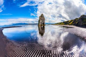 Magic Rock Hvitsercur at sunset. Northern coast of Iceland. The picture was taken Fisheye lens. Concept of extreme northern tourism