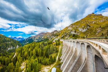  Mountain Lake Lago di Fedaia, Dolomites. Powerful dam blocked the lake. The concept of ecological and extreme tourism