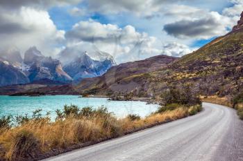 Chile, Patagonia. Torres del Paine National Park - Biosphere Reserve. Concept of ecotourism. The road around the lake Pehoe