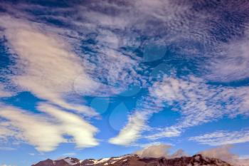 Striped clouds over Ice lagoon Jokulsarlon, Iceland. The concept of northern extreme tourism