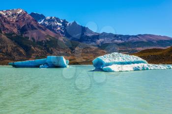 Argentina Patagonia, emerald water of the lake Viedma. Huge white-blue ice floe drifts from coastal glacier