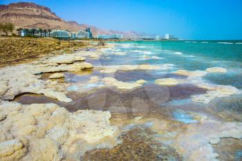 Evaporated salt along the shore of the Dead Sea. Israel, spring. The concept of ecological and medical tourism