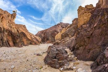 Israeli warm winter. Picturesque and multi-color Black canyon in ancient Eilat mountains