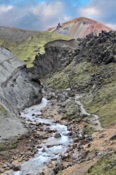 National Park Landmannalaugar in Iceland. Creek at the bottom of a picturesque gorge and the path down the mountainside