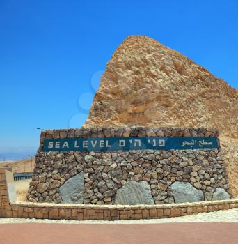 Highway built in the valley of the Dead Sea in Israel. On the side of a highway sign Sea Level