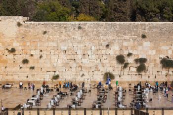 Autumn holiday Sukkot. The area in front of the greatest shrine of Judaism. The Western Wall of the Temple is preparing for evening prayer