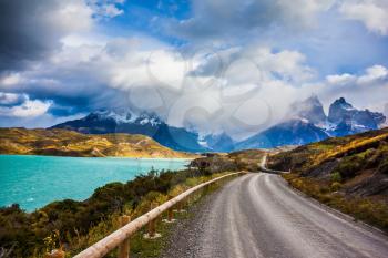 The road around lake Pehoe. Concept of ecotourism. Chile, Patagonia. Torres del Paine National Park - Biosphere Reserve
