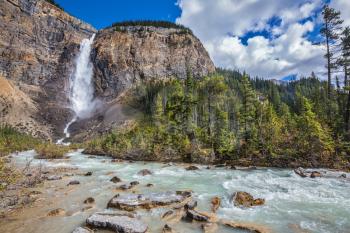Rocky Mountains of Canada. Yoho National Park. Autumn full-flowing waterfall Takakkaw forms water flow of pearl color