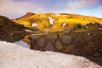 Magic sunrise in the Arctic. The golden light of dawn illuminates the mountains and glaciers national park Landmannalaugar, Iceland