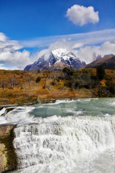 South of Chile. Scenic powerful and high-water waterfall Cascades Paine in the national park Torres del Paine