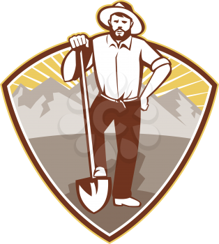 illustration of a gold digger miner prospector with shovel spade done in retro style set inside shield with mountains in background.