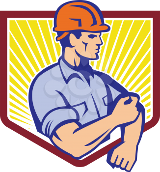 Illustration of a construction worker wearing hardhat rolling up sleeve facing side set inside shield done in retro style