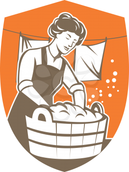 Illustration of a housewife washing laundry using wooden bucket with clothes hanging in line set inside shield crest shape done in retro style.