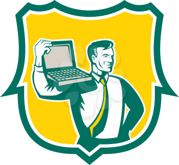Illustration of a computer geek technician man carrying computer laptop on shoulder looking to the side set inside shield on isolated background done in retro style. 
