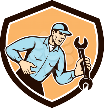 Illustration of a mechanic wearing hat shouting yelling holding spanner wrench looking to the side set inside shield crest on isolated background done in retro style.