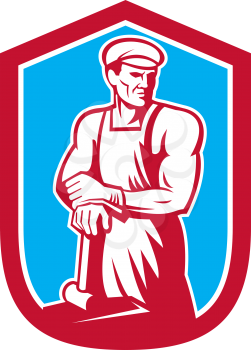 Illustration of a foundry worker blacksmith leaning on hammer facing front set inside shield shape done in retro style.
