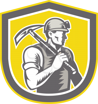 Illustration of a coal miner wearing hardhat with pick axe facing side set inside shield crest done in retro woodcut style.
