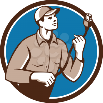 Illustration of a worker technician holding hdmi plug cord looking to the side set inside circle on isolated background done in retro style. 