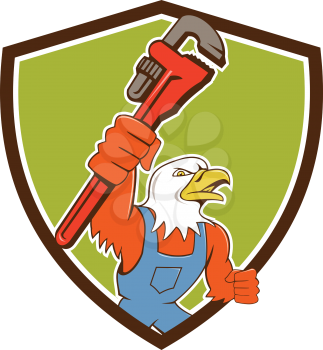 Illustration of an american bald eagle plumber holding monkey wrench looking to the side set inside shield crest done in cartoon style. 