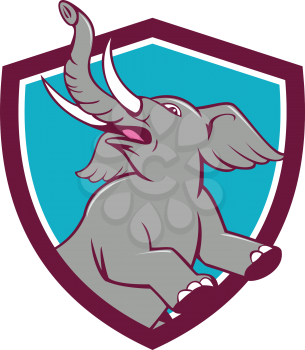 Illustration of an african elephant prancing looking up to the side set inside shield crest on isolated background done in cartoon style. 