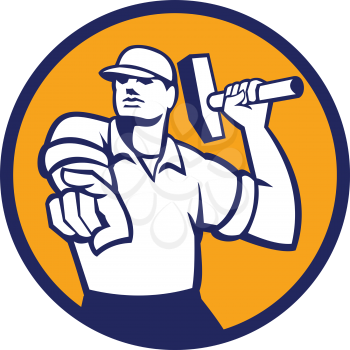 Illustration of a demolition worker wearing hat pointing holding hammer ready to strike set inside circle on isolated background done in retro style.