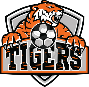Sports mascot icon illustration of a tiger with soccer football ball viewed from front set inside shield, crest or badge with text Tigers on isolated background in retro style.