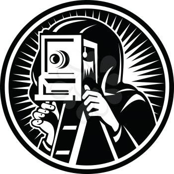 Retro woodcut style illustration of a photographer shooting taking photo using a vintage box camera viewed from front set inside circle on isolated background done in black and white.