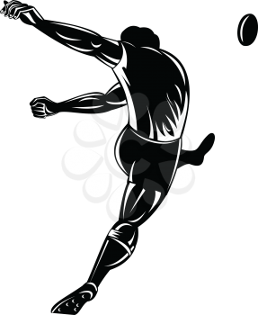 Retro woodcut style illustration of a rugby player or kicker kicking the ball viewed from rear or back  on isolated background done in black and white.