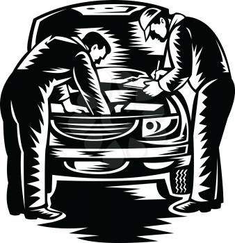 Retro woodcut style illustration of two automotive mechanic doing vehicle car service and repair viewed from front on isolated background done in black and white.