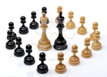 Several wooden chess pieces light and dark colors.