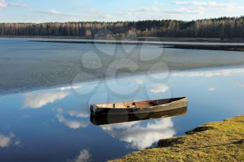 Royalty Free Photo of a Boat in the Water With the Ice Receding