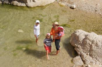 Royalty Free Photo of People Wading in Water at the Ein Gedi Nature Reserve off the Coast of the Dead Sea.