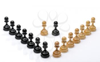 Several wooden chess pieces light and dark colors.