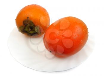 Royalty Free Photo of a Persimmon on a Plate