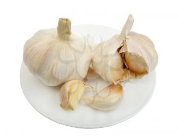 Garlic on a white plate on a white background, isolated