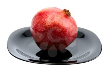 Royalty Free Photo of a Pomegranate on a Black Plate