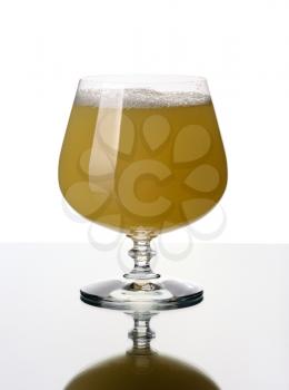 Glass goblet with a juice, isolated on a white background.
