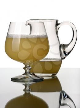 Glass pitcher and goblet, isolated on a white background.
