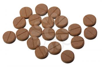 Several brown pills on a white background, isolated